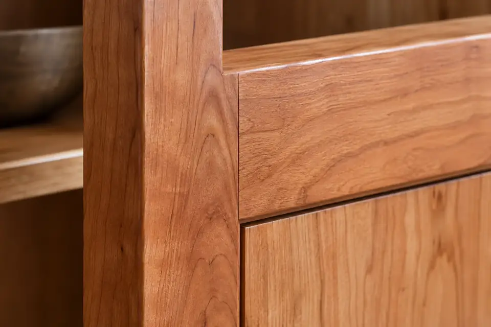 Solid cherry stile meeting a rail at a tight mortise and tenon shoulder